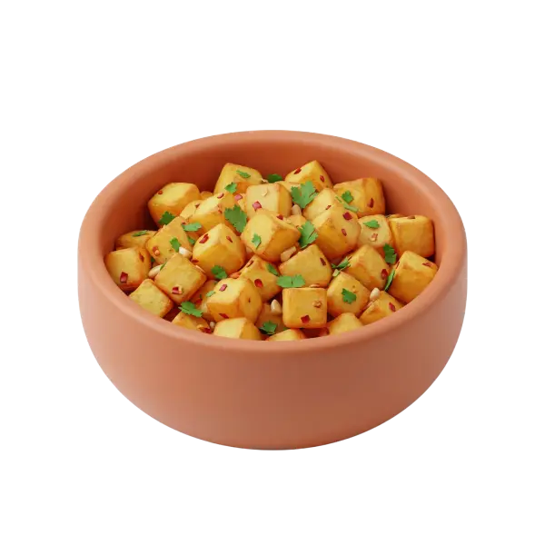3D render of a terracotta bowl filled with cubed golden fried potatoes sprinkled with red chili flakes, green cilantro leaves and small nuts, shown against a black isolated background.